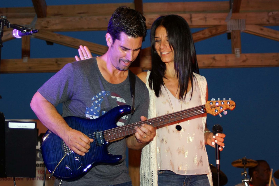 Mike Risko Band. Mike playing his guitar as Miriam sings and looks over to him